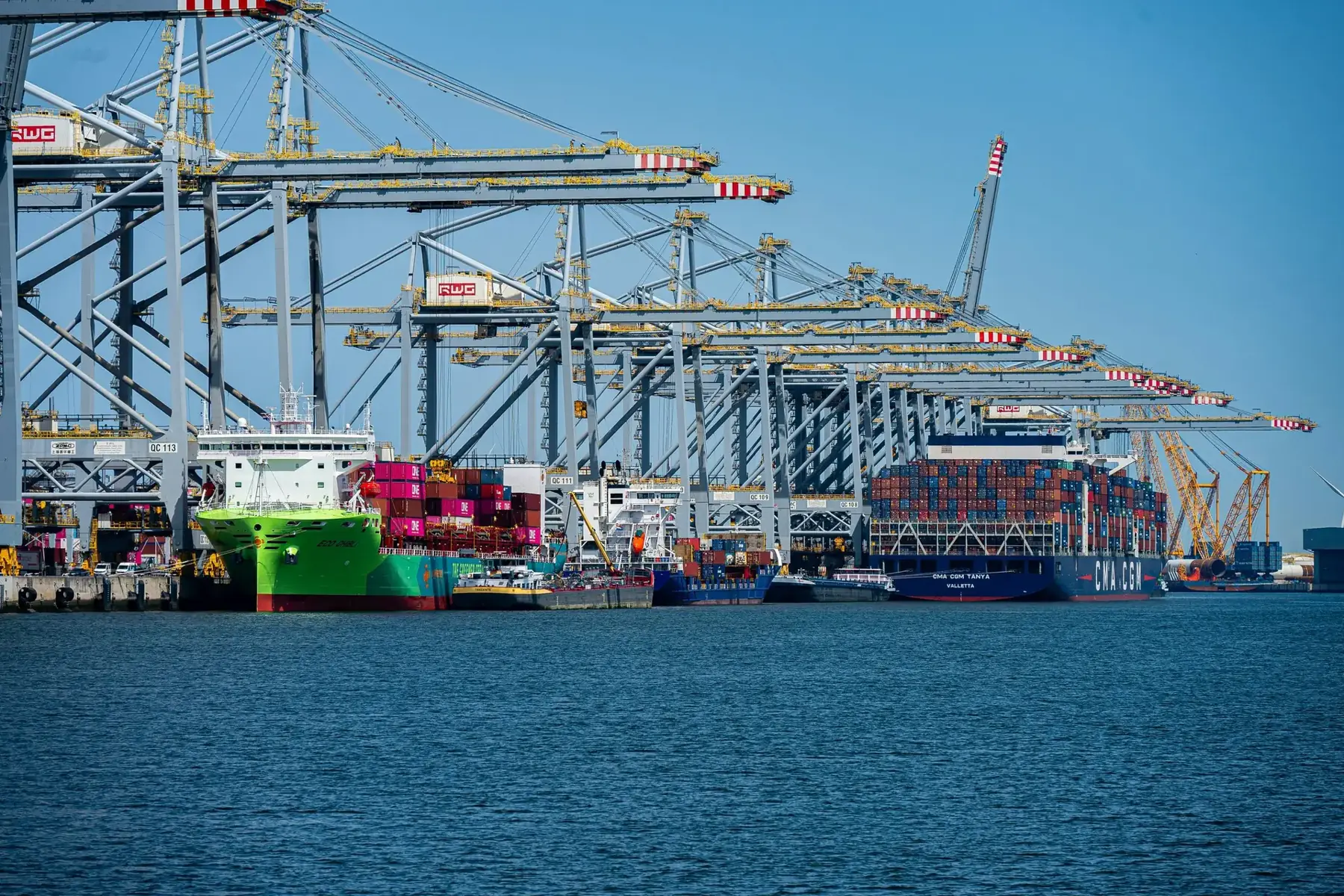Ship-to-shore cranes working vessels at a deep-water terminal