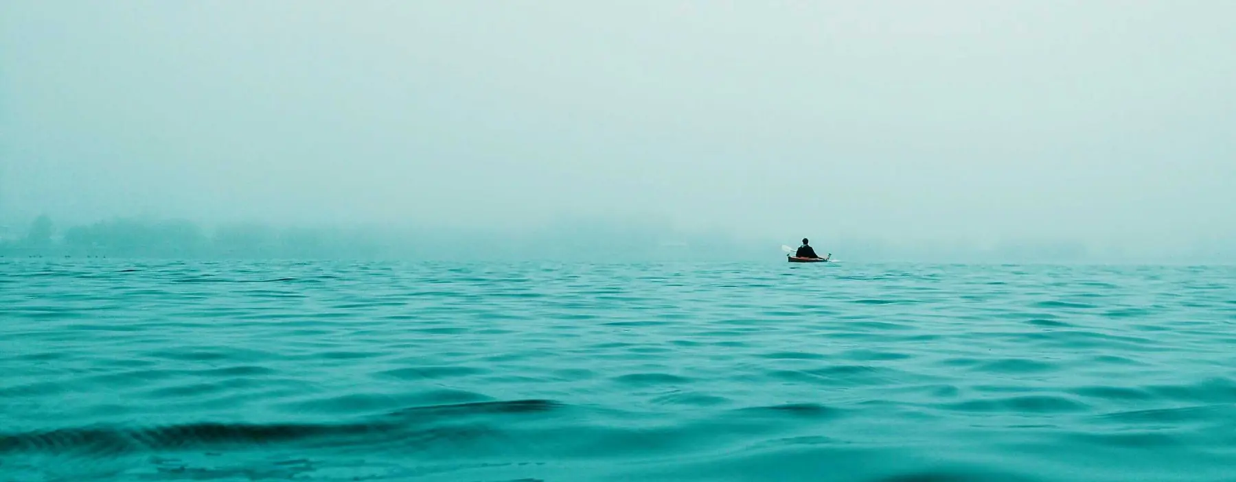 Lone vessel on calm turquoise open water